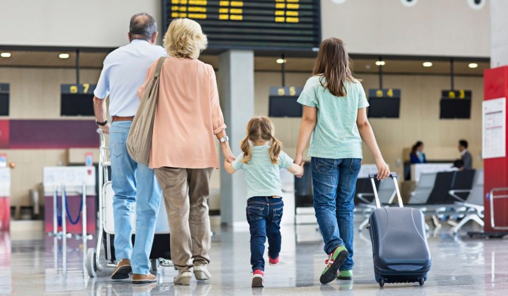 grandparents with their grandkids at the airport