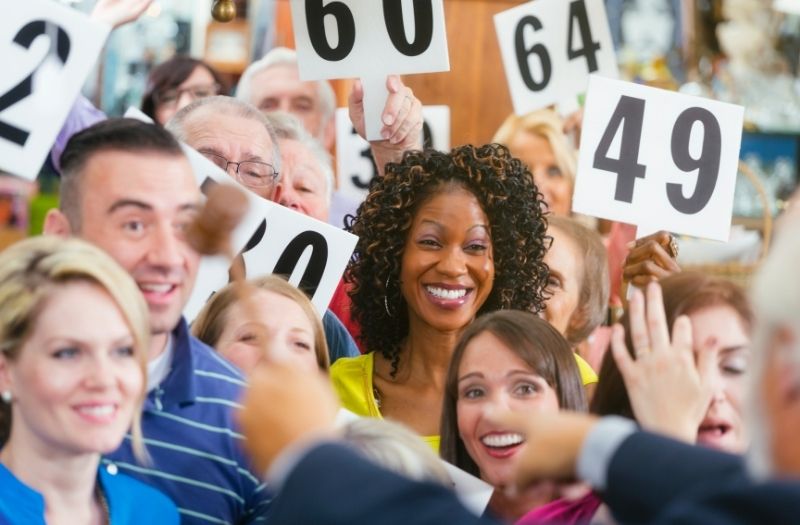 happy woman in an auction show