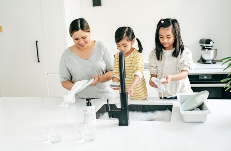 mommy and daughters washing the dishes together