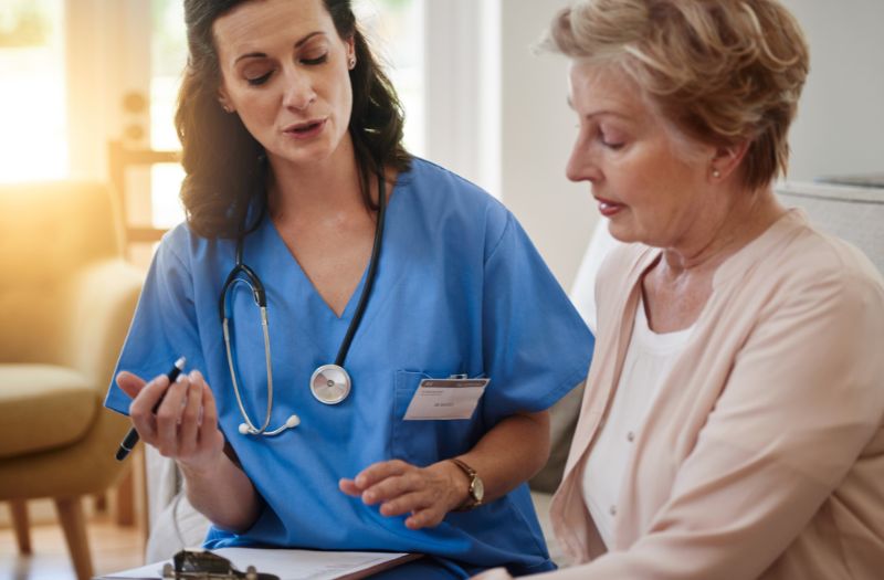 nurse explaining something to the senior lady