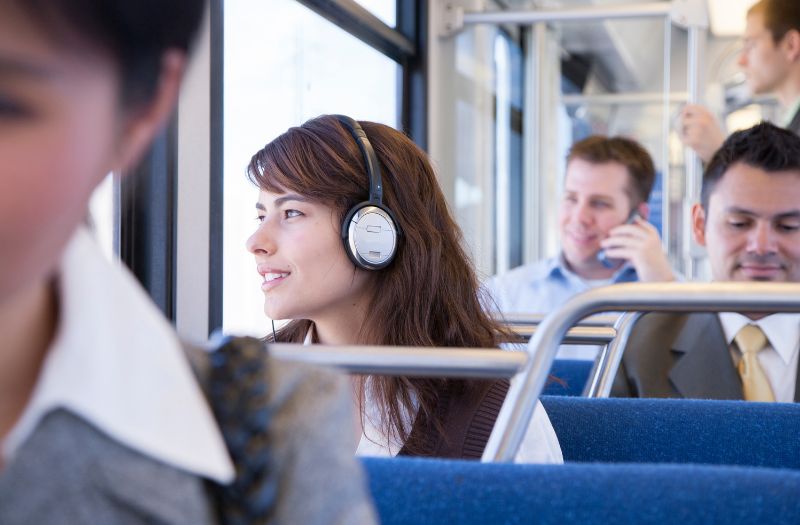 woman commuter wearing her headphones in the bus