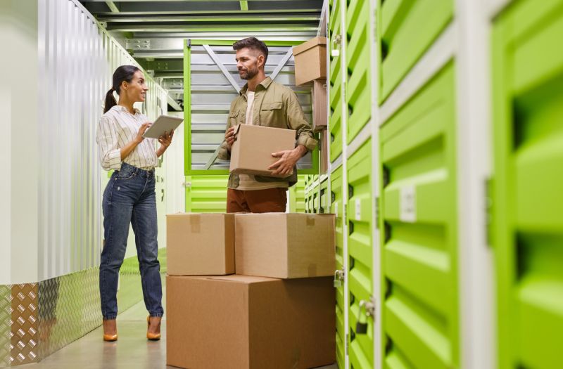 couple doing inventory on the things they have in a storage unit