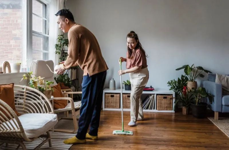 couple cleaning their living area