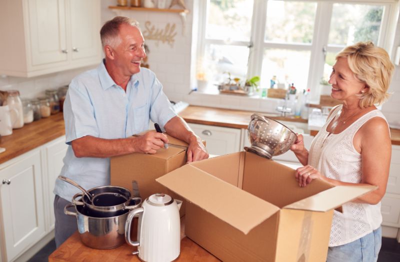 senior couple packing some kitchen stuff